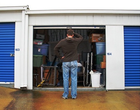 Man Trying to Organize his Storage Unit